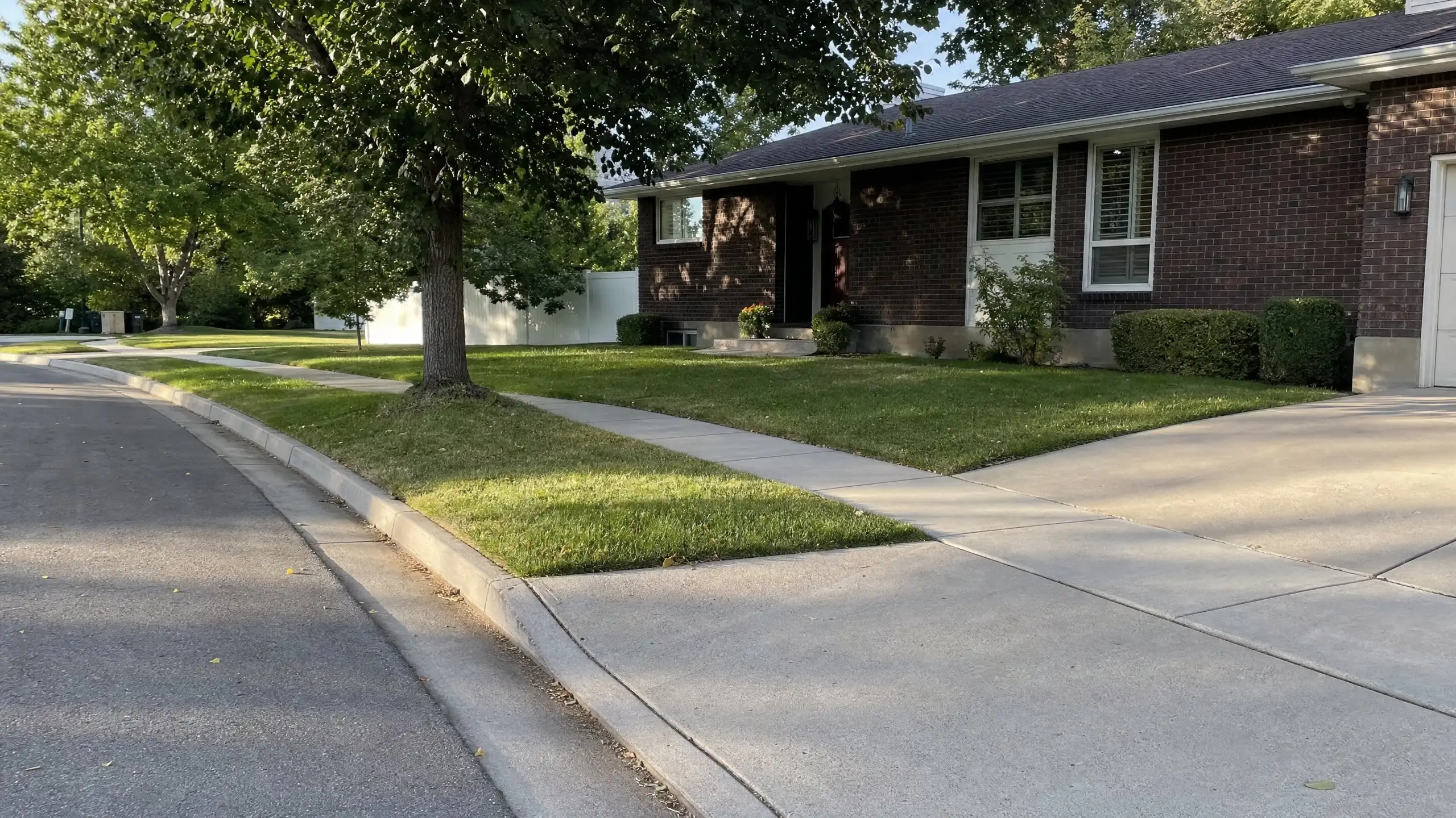 Curb, gutter, sidewalk and driveway approach in front of a home before construction starts