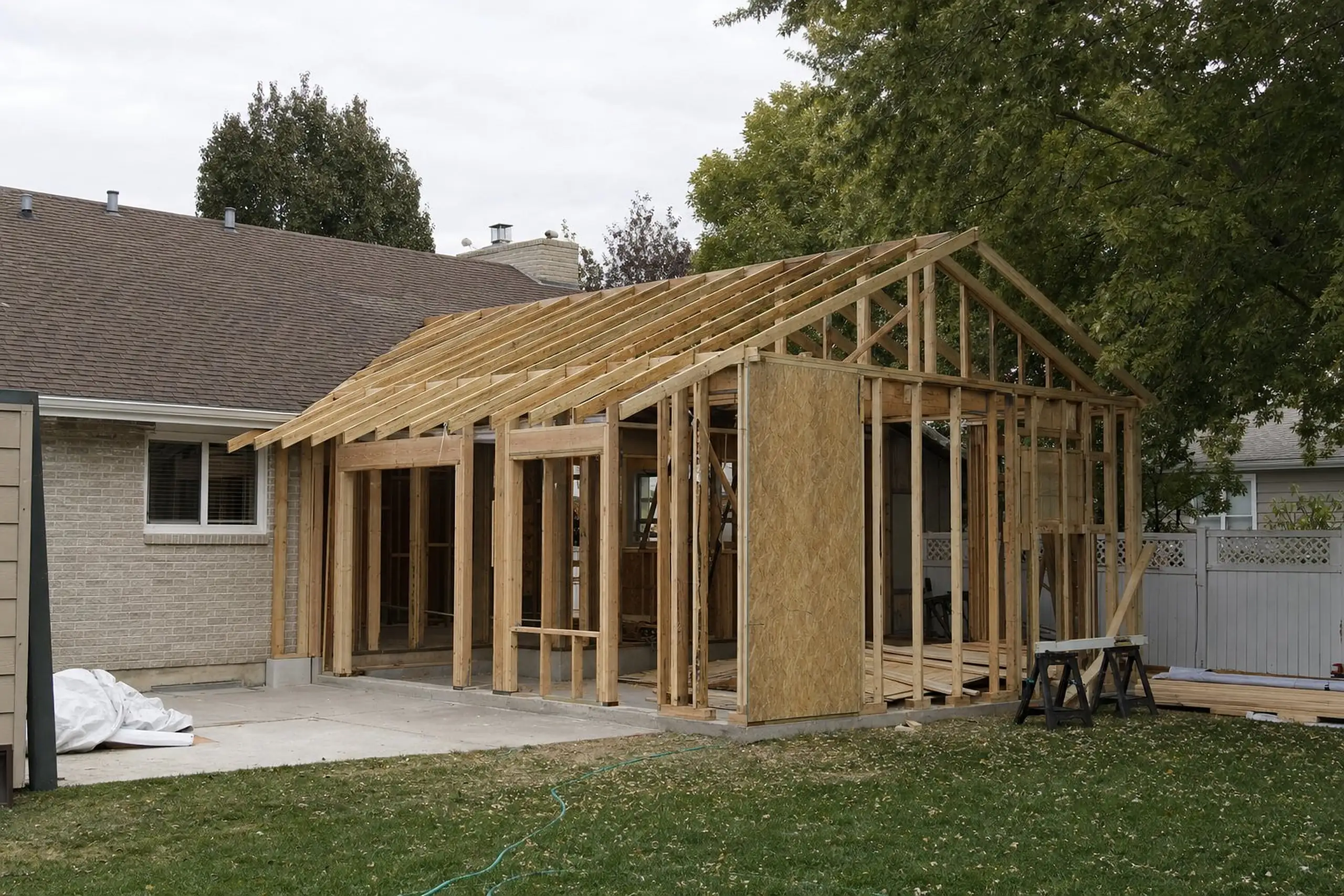 Wall and roof framing for a new addition tied into the side of an existing house