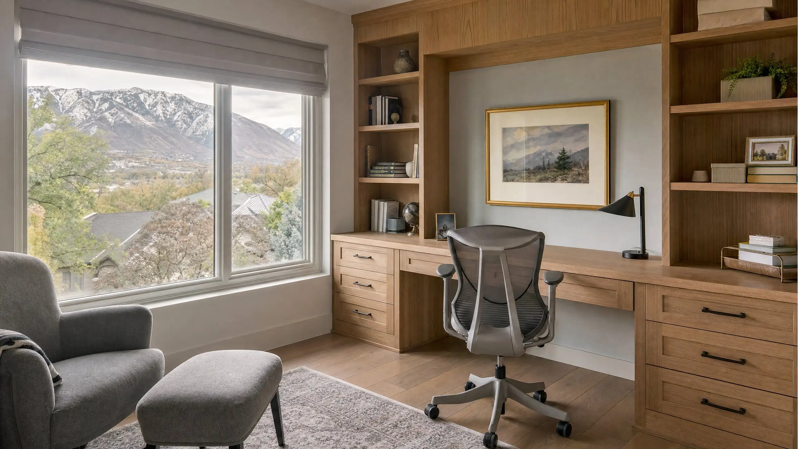 Home office addition with a built-in oak desk and shelves and a window facing the mountains