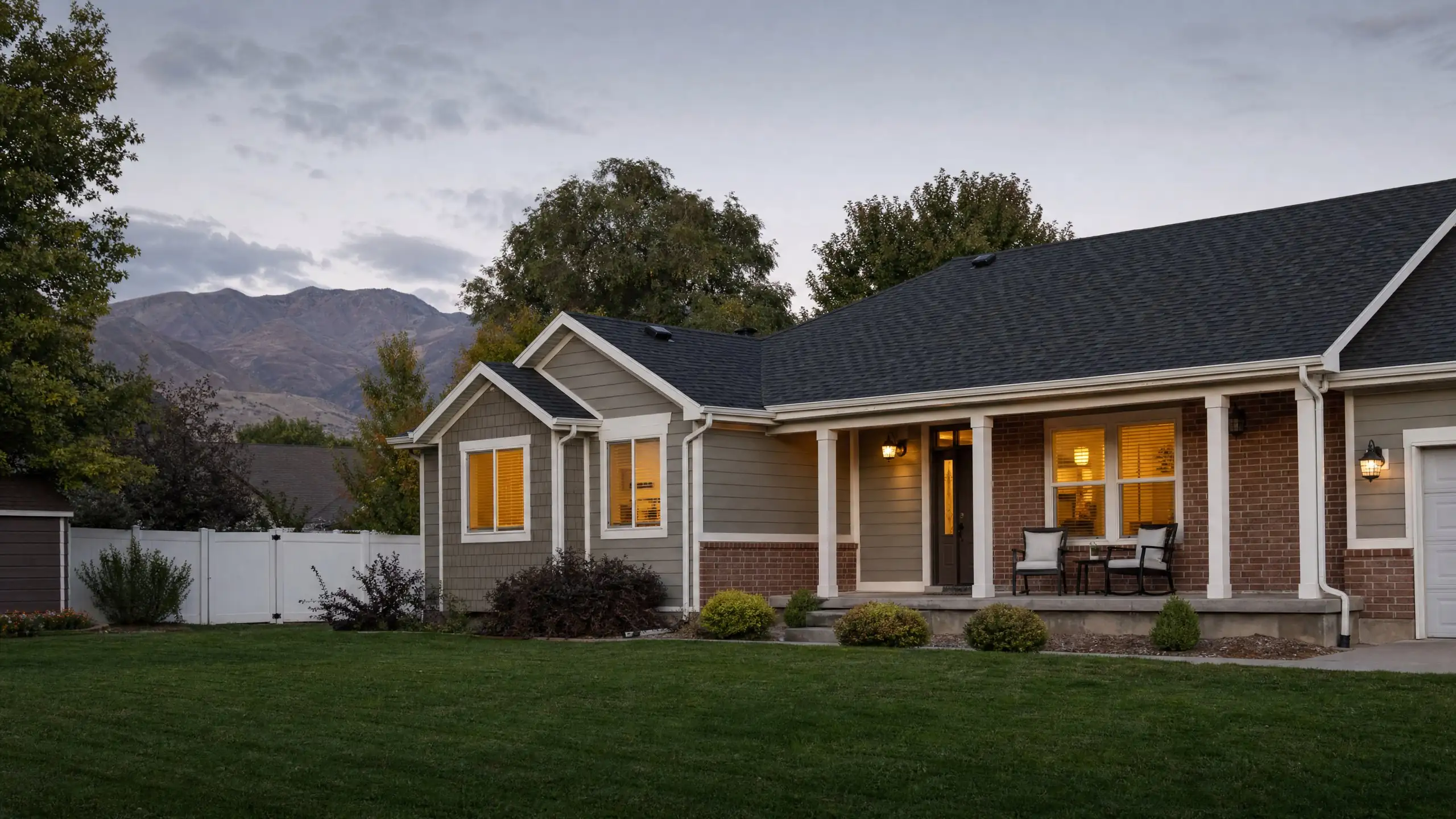 Utah home with a matching side addition and a covered porch in early evening light